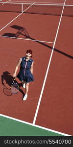 young fit woman play tennis outdoor on orange tennis field at early morning