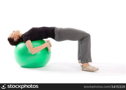 Young fit woman with gym ball doing pilates exercise, isolated on white background.