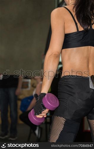 Young Fitness Girl with Black Sportswear Lifting Weights in Gym