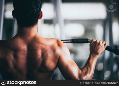 young fitness person execute exercise with exercise-machine in gym