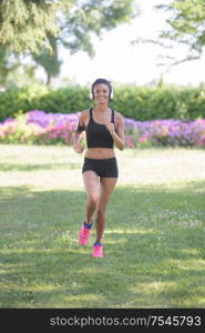 young fitness sports woman runner running on park trail