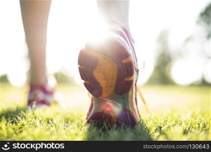 Young fitness woman running, Training and healthy lifestyle. Runner feet running on road closeup on shoe