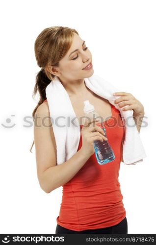 young fitness woman with a bottle of water looking to side. young beautiful blonde fitness woman with a bottle of water looking to side on white background