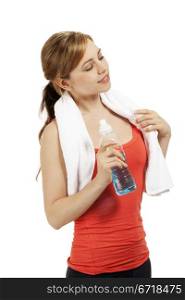 young fitness woman with a bottle of water looking to side. young beautiful blonde fitness woman with a bottle of water looking to side on white background