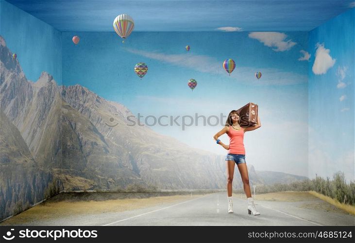 Young free hitchhiker. Traveler woman walking with retro suitcase on shoulder