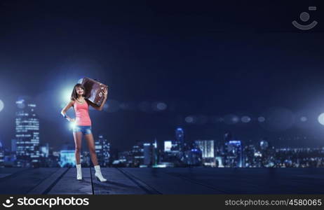 Young free hitchhiker. Traveler woman with retro suitcase waiting for car