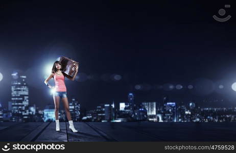 Young free hitchhiker. Traveler woman with retro suitcase waiting for car