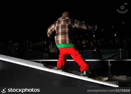young free style snowboarder jumping in air and make acrobations