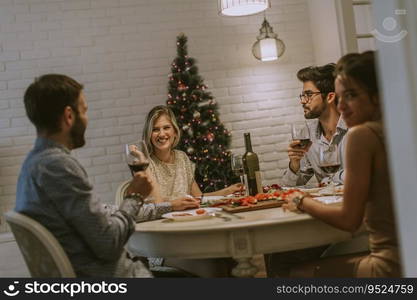 Young friends celebrating Christmas or New Year eve at home