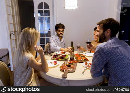 Young friends celebrating Christmas or New Year eve at home