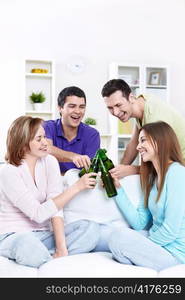 Young friends drinking beer at home