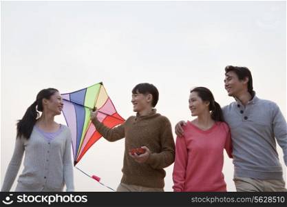 Young Friends Flying a Kite on the Beach