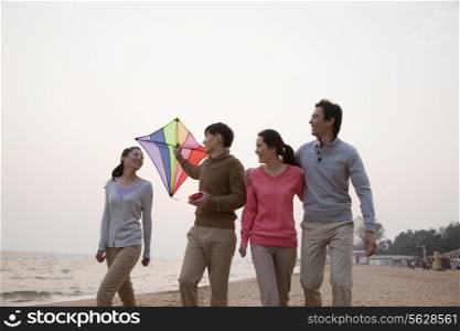Young Friends Flying a Kite on the Beach