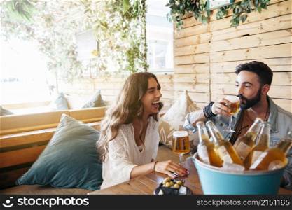 young friends laughing drinking