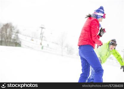 Young friends playing in snow