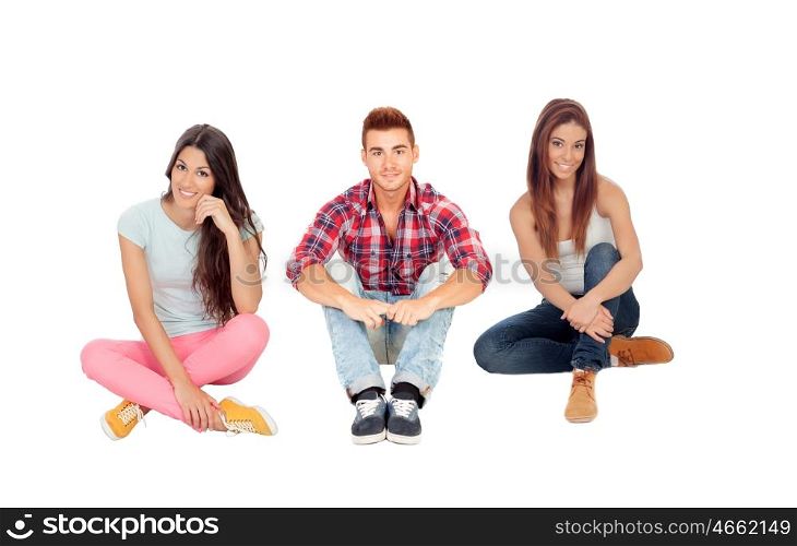 Young friends sitting on the floor isolated on white