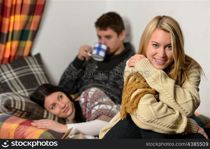 Young friends spend winter holiday in cozy cottage wear warm jumpers