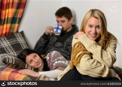 Young friends spend winter holiday in cozy cottage wear warm jumpers