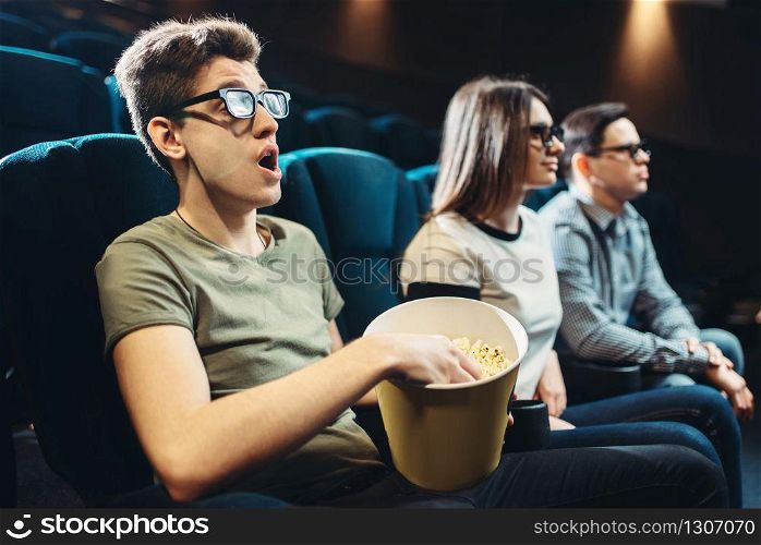 Young friends watching 3d movie in cinema together. Showtime, entertainment industry technologies