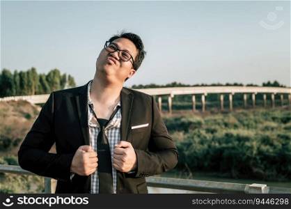 Young funny Asian Busi≠ssman wearing shirt and tie with shorts and eyeglasses in crazy and funny man≠r posture,©space