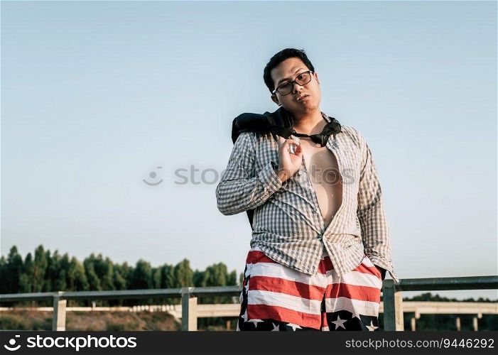 Young funny Asian Businessman wearing shirt and tie with shorts and eyeglasses in crazy and funny manner posture, copy space