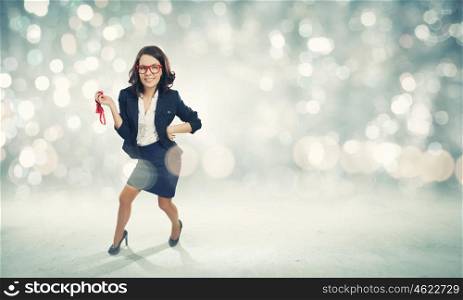 Young funny businesswoman in suit against bokeh background. Funny businesswoman