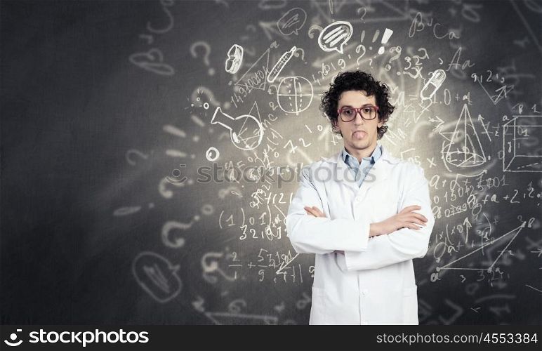 Young funny doctor. Crazy male doctor in glasses showing tongue
