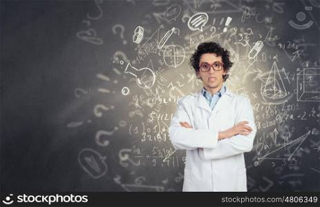 Young funny doctor. Crazy male doctor in glasses showing tongue