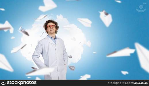 Young funny doctor. Young funny doctor in glasses and paper planes flying around