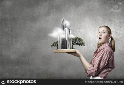 Young funny girl with opened book in hands. Girl excited with book