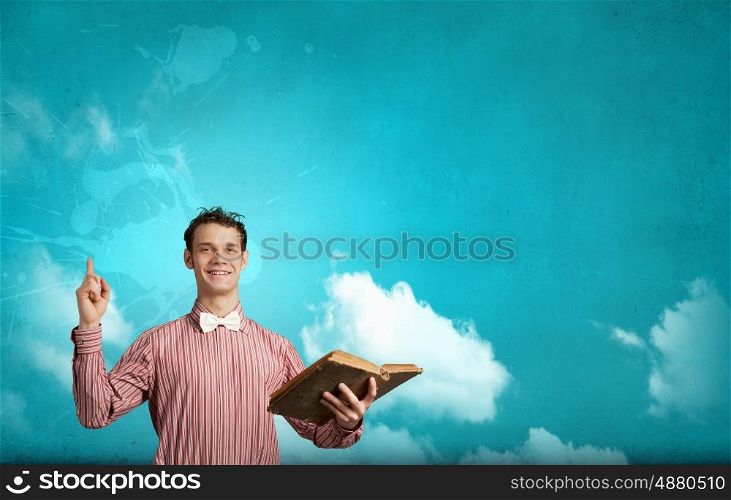Young funny man with book in hands. I like reading