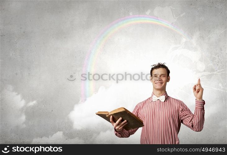 Young funny man with book in hands. I like reading
