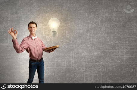 Young funny man with book in hands. I like reading