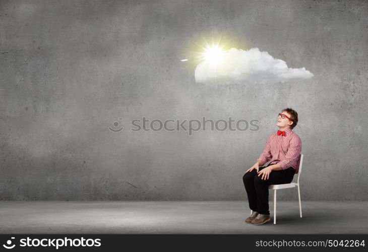 Young funny teenager guy sitting in chair. Funny man