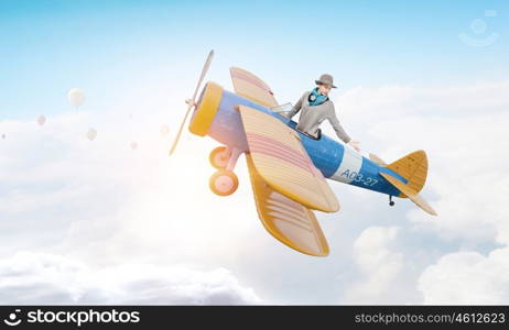 Young funny woman flying in air in retro airplane. Girl flying old plane