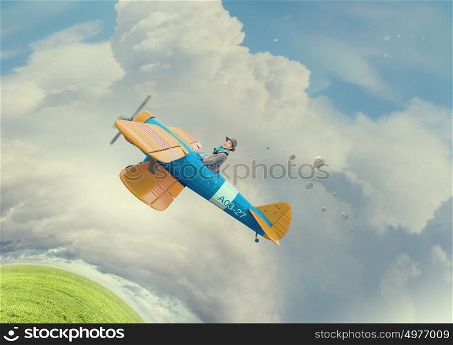 Young funny woman flying in air in retro airplane. Girl flying old plane