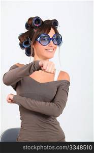 Young funny woman with hair-curlers