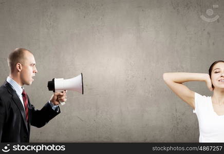 Young furious woman screaming agressively in megaphone. Agressive management