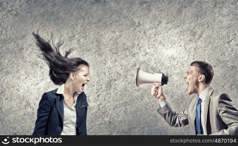 Young furious woman screaming agressively in megaphone. Agressive management