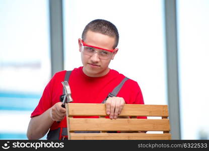 Young furniture carpenter in industrial concept