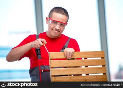 Young furniture carpenter in industrial concept