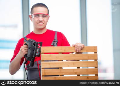 Young furniture carpenter in industrial concept