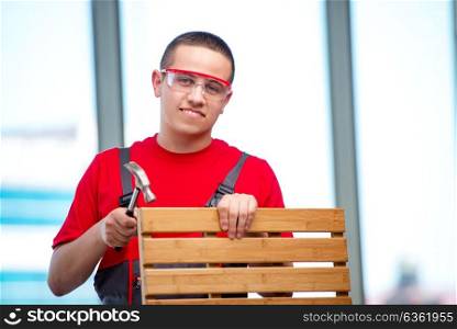 Young furniture carpenter in industrial concept
