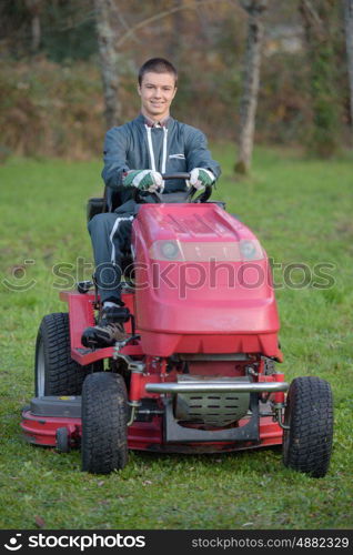 young gardener on a lawn tractor