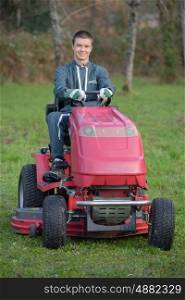 young gardener on a lawn tractor