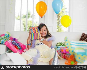 Young girl (7-9) opening birthday presents