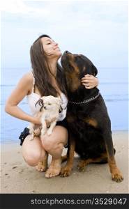 young girl and her two dogs on the beach