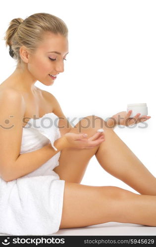 Young girl applying body cream isolated