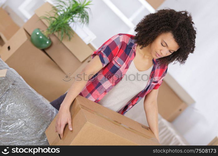 young girl arranging interior and unpacking at new apartment