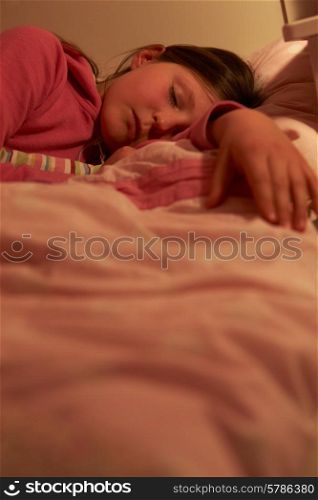 Young Girl Asleep In Bed At Night